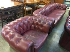A burgundy Chesterfield four seater settee and Club armchair