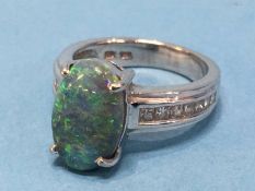 A ladies 18ct ring, mounted with diamonds and a black opal, approx. 1.4ct