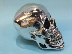 A resin skull, 28cm x 17cm