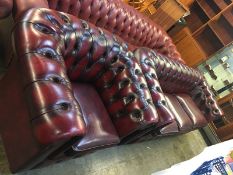 An Oxblood Chesterfield three seater settee and Club armchair