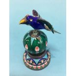 A cloisonné figure of a bird seated on a ball