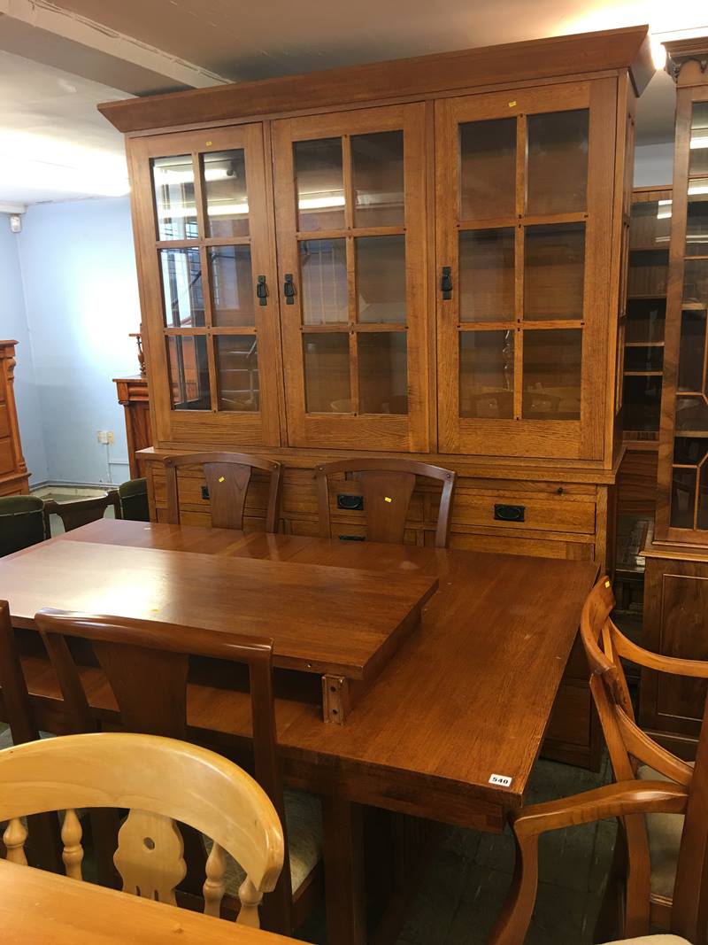 A large oak kitchen dresser with matching extending table and six chairs