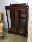 A reproduction mahogany china cabinet