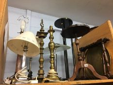 Brass folding table and a shelf of lamps