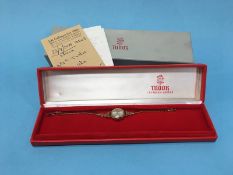 A ladies 9ct gold wristwatch, dial signed Tudor, together with box and paperwork