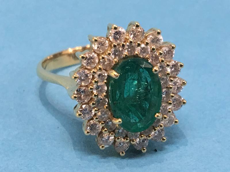 An 18ct emerald and diamond ring, central emerald approx. 2.75 carat, size 'S', 8g