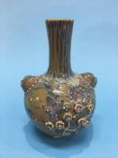 An Oriental vase, in mustard and blue glaze, decorated with flowers