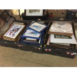 Three boxes of framed prints