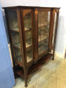 An Art Nouveau mahogany china cabinet, with leaded glass central door