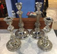 Two pairs of plated candlesticks