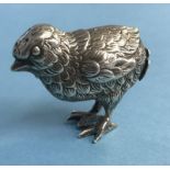 A white metal chick pepper pot