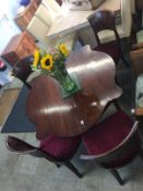 A mahogany fold over table and four chairs