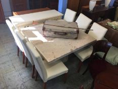 A marble square top dining table, six chairs and a cream sideboard