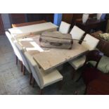 A marble square top dining table, six chairs and a cream sideboard