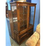 An oak leaded glass display cabinet