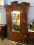 An Edwardian marble top washstand with tiled back and a mirror door wardrobe