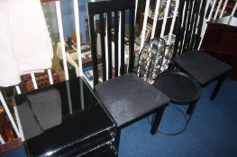 A chrome and black glass nest of tables, two ebonised chairs etc.