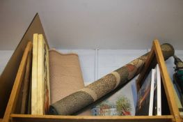 A shelf of canvas prints and rugs