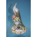 A Royal Crown Derby peacock on floral stand, signed P. Whittaker