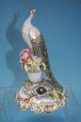 A Royal Crown Derby peacock on floral stand, signed P. Whittaker