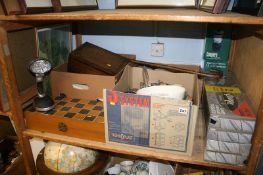 A shelf of miscellaneous , including china and two dynamo lanterns