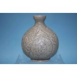 A bulbous celadon vase, with carved leaf decoration, 20cm high