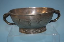 A Chinese pewter bowl with jade handles, 18cm diam