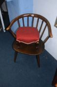 An Ercol chair and a footstool