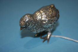 A silver metal pepper pot in the form of a chick