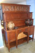 An Arts and Crafts style dresser with pierced step