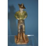 A Royal Worcester figure of a man wearing a hat, with his hands in the tops of his trousers, puce