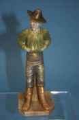 A Royal Worcester figure of a man wearing a hat, with his hands in the tops of his trousers, puce