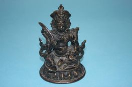 A Tibetan bronze figure of a Deity, 11cm high