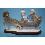 A Lladro group of a dog pulling two children on a