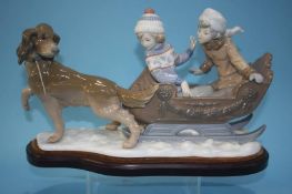 A Lladro group of a dog pulling two children on a