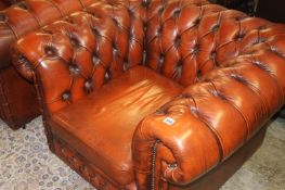 A Chesterfield three seater settee and club chair