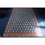 A Turkish Kilim, midnight blue ground, all-over geometric floral sprays and terracotta border, 266cm