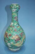 A Chinese bottle shape vase on a pale green ground