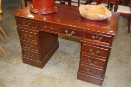 A reproduction mahogany pedestal desk