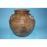 A large Oriental brown glaze and earthenware vase, decorated with dragons, 30cm high