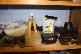 A shelf of miscellaneous including a footbath and a selection of hats