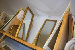 A shelf of four mirrors