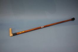 A walking cane with silver mount