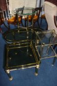 A collection of four various glass top tables
