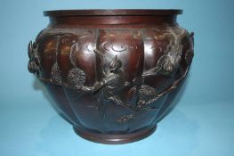 A large bronze jardinière, decorated with birds and foliage, 36cm diameter, 28cm high