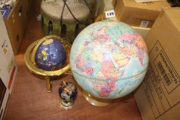 Three globe atlases on stands