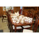 A mahogany extending dining table and set of eight chairs