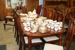 A mahogany extending dining table and set of eight chairs