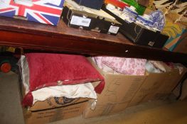 Four boxes of cushions, fabric etc.