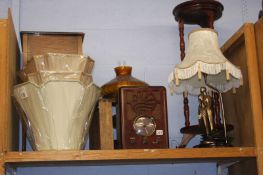 A shelf of assorted, radio sets, lamps etc.